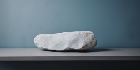 Fototapeta na wymiar Flat Cubic Rock Resting on a Grey Block Rocky Table, Embracing Light White Aesthetics and Clean Minimalist Composition for a Contemporary and Tranquil Artistic Still Life