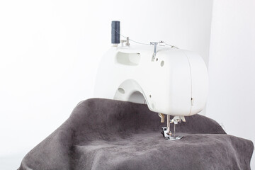 Sewing machine, stitching fabrics, needle in a round plan