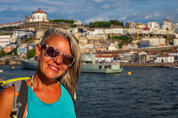 Porto, Portugal - Female traveller enjoying the stunning sunset above the Douro river in Porto during summer