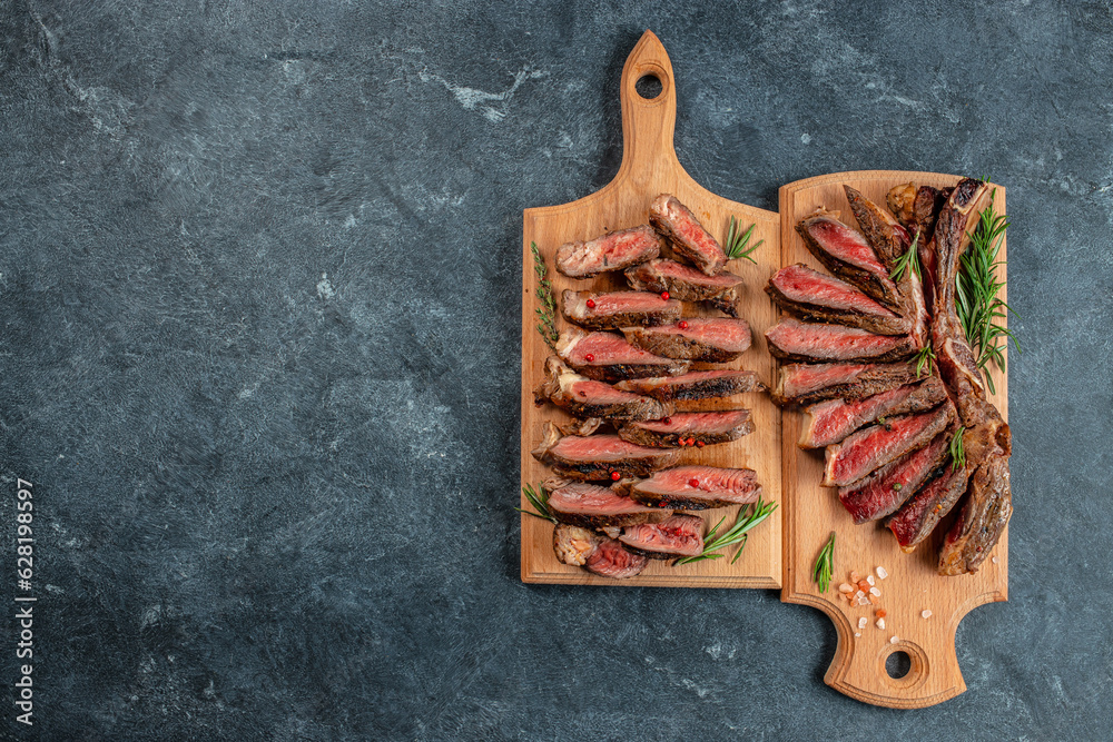 Wall mural Marbled beef steak medium rare on a dark background. Healthy fats, clean eating for weight loss. top view. place for text