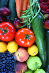 Wooden crate full of healthy colorful seasonal fruit and vegetable. Top view.