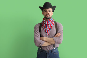 Handsome cowboy on green background