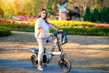 Asian woman riding a bicycle at the park