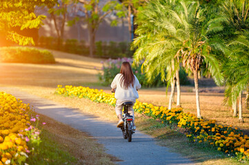 Asian woman riding a bicycle at the park