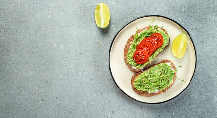 Avocado Toast and tomatoes on light background. Vegetarian food. Vegan menu. Long banner format. top view
