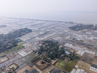 Naklejka premium Aerial view of natural salt field on the coast of bashkhali Island in Chittagong, Bangladesh.