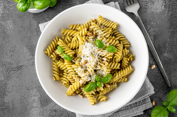 Fussili pasta with basil pesto sauce, parmesan cheese and pine nuts. Traditional Italian food.