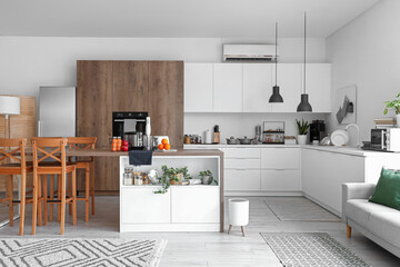 Interior of light kitchen with modern appliances on wooden table