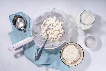 Making cottage cheese, homemade fermenting dairy product. Homemade cottage cheese in cheesecloth...
