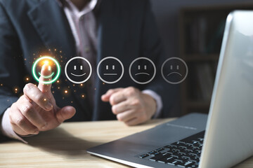 a businessman choose the virtual screen on the happy smile face icon to give satisfaction in service.rating very impressed.customer review service and Satisfaction concept