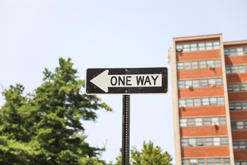 one-way sign on a city street, symbolizing direction, restriction, and adherence to a predefined path in life. Decisions and choices