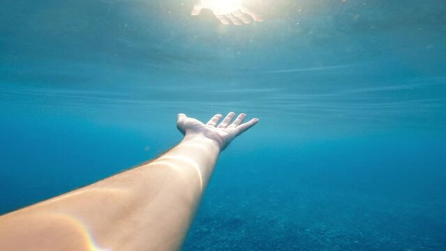 hand touches the sea water
