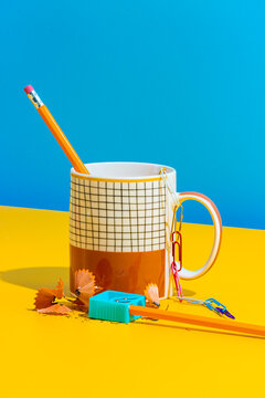 Cup with pencil and paper clips near sharpener