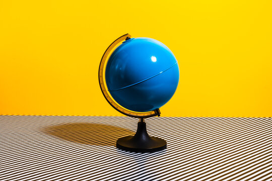 Globe placed on striped surface