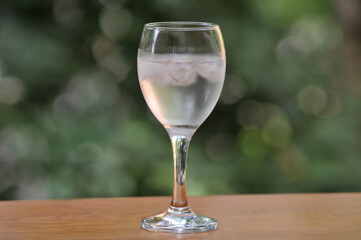 Mineral water in a wineglass with ice