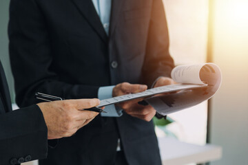 Teamwork with business people analysis cost graph on desk at meeting room.