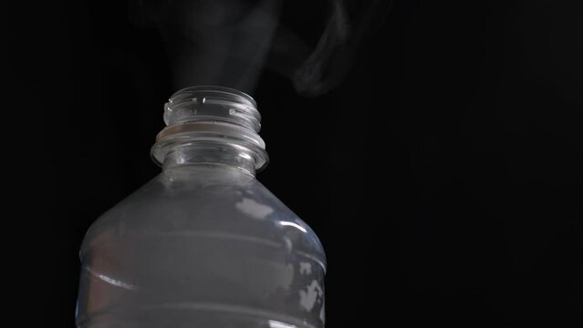 Smoke from a burning plastic bottle, close-up