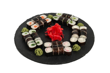 sushi set. different types of sushi on a big round black dish. Sushi set on a black slate.