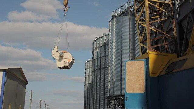 Lifting of oversized cargo. A construction crane lifts ventilation units at a construction site