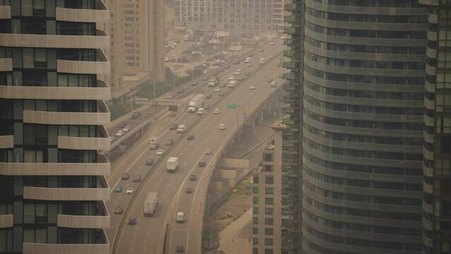 Wildfire Smoke Haze Over Gardiner Expressway Traffic Between Condo Towers, Toronto, Canada, 4K
