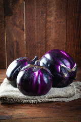 Fresh Eggplants over Wooden Rustic Background, Purple Round Eggplants