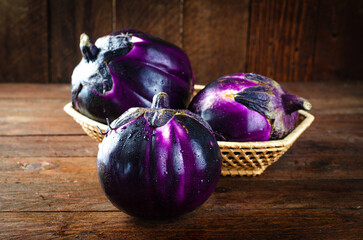 Fresh Eggplants over Wooden Rustic Background, Purple Round Eggplants