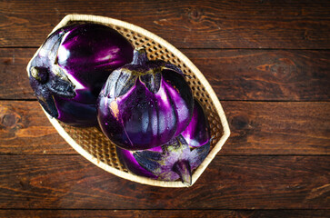 Fresh Eggplants over Wooden Rustic Background, Purple Round Eggplants