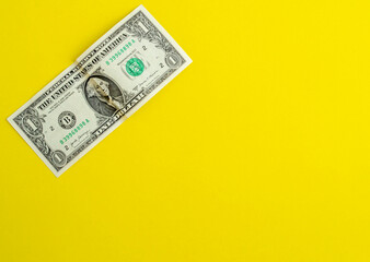 Dollar on a yellow background, background with copy space for advertising.