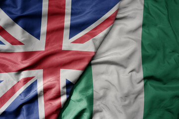 big waving national colorful flag of great britain and national flag of nigeria . - obrazy, fototapety, plakaty
