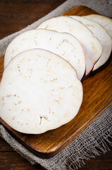 Fresh Sliced Eggplants over Wooden Rustic Background, Purple Round Eggplants