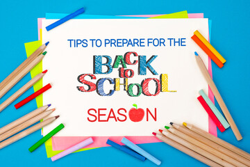 Tips to prepare for Back to School. Top view flat lay concept. Lettering, colored paper, multi-coloured letters, supplies for school