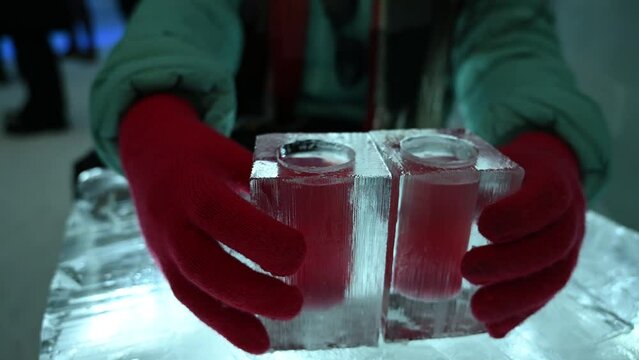  Ice glass with colorful drinks. Visit of Ice Hotel. The attraction for visitors.