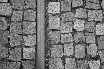Black and white art photo with masonry and steel strip. Concept photo: stone and steel.