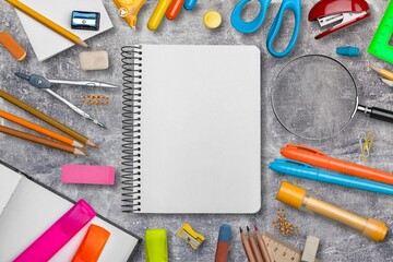 Blank paper with school supplies on desk