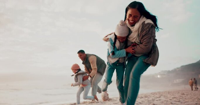 Travel, playful and family running on beach while on a tropical vacation, adventure or holiday. Happy, smile and children exploring on the sand by ocean with their parents on a fun weekend trip.