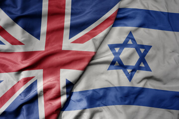 big waving national colorful flag of great britain and national flag of israel .