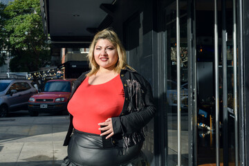 young plus size latin woman walking outside restaurant