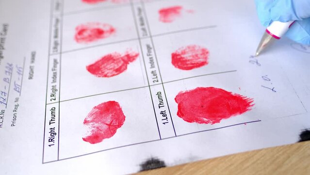 close-up of policeman fills out document, police fingerprint card, police examination of suspected person, personality identification concept, sweat traces from crime scene, police investigation