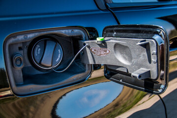 Open gas tank of a black car close-up