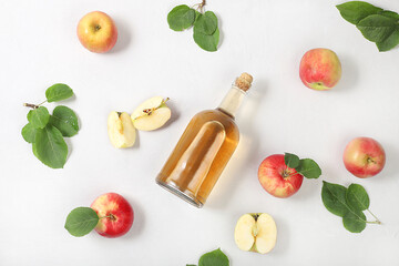 Apple cider drink, juice or fermented fruit drink and ingredients on a sunny table. Autumn banner....