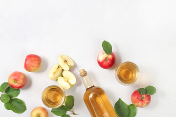 Apple cider, juice or fruit drink and ingredients on a sunny table. The concept of diet and weight loss. Apples help cleanse the body and reduce weight. Healthy food, body detoxification,