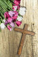 Christian wooden cross with fresh flower branches blossoms