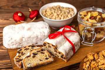 Christmas stollen on wooden background. Traditional Christmas festive pastry dessert. Holiday concept. Dessert, cake, pie with marzipan, nuts and dried fruits. Stollen for Christmas. Spicy pastries.