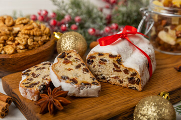 Christmas stollen on wooden background. Traditional Christmas festive pastry dessert. Holiday concept. Dessert, cake, pie with marzipan, nuts and dried fruits. Stollen for Christmas. Spicy pastries.