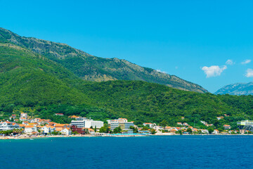 Naklejka na ściany i meble seascapes, a view of the Bay of Kotor during a cruise on a ship in Montenegro, a bright sunny day, mountains and small towns on the coast, the concept of a summer trip