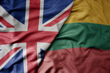 big waving national colorful flag of great britain and national flag of lithuania .
