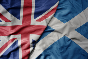 big waving national colorful flag of great britain and national flag of scotland .