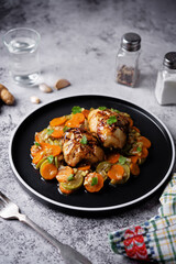 Moroccan spiced chicken with zucchini and carrots in a plate