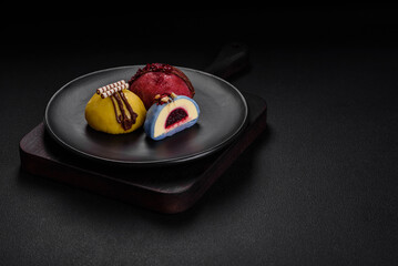 Delicious sweet colorful mochi desserts or ice cream with rice dough and toppings