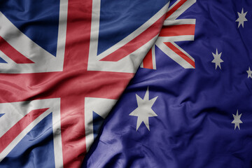 big waving national colorful flag of great britain and national flag of australia .